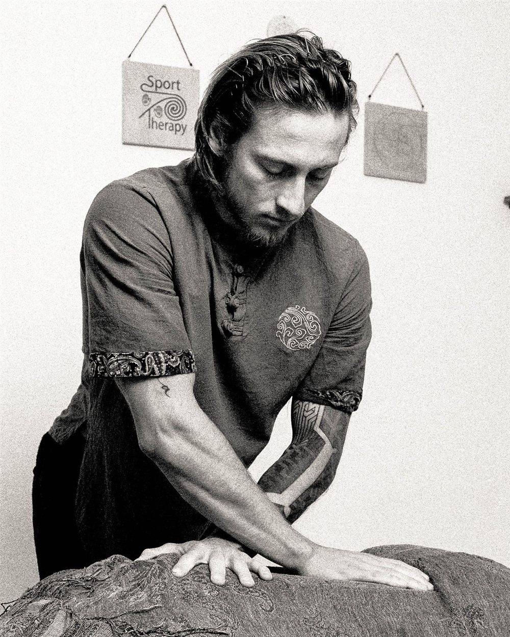 Karol leaning into a deep tissue technique on a client's back