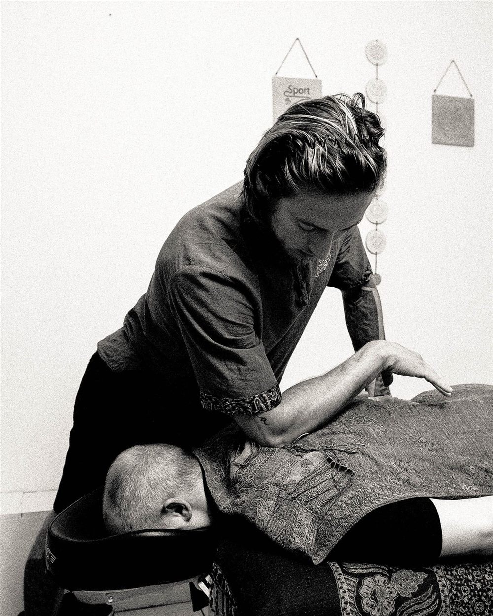 Karol working on a client lying face-down on the treatment table